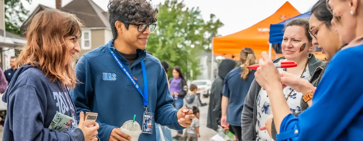 A group of people enteracting at a community event.